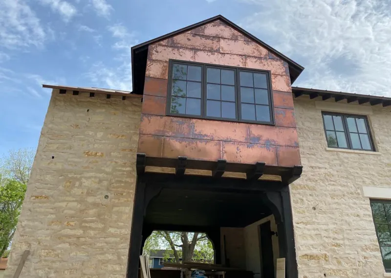 Copper metal panel facade on a stone building for Metal Roof Coating in Cleburne